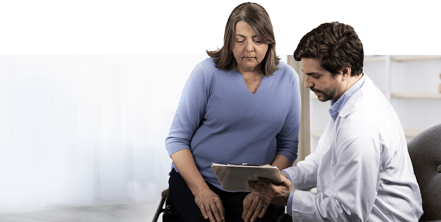 Doctor reviewing chart with WHIM syndrome patient